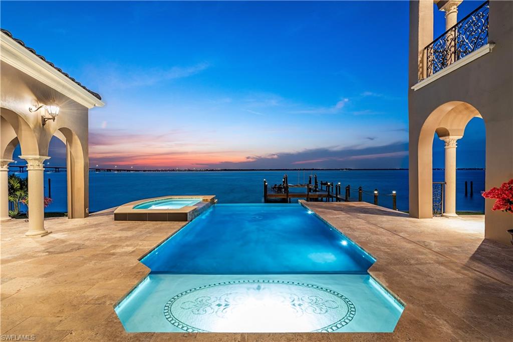Welcome to 3914 W Riverside Drive. This stunning Caloosahatchee riverfront estate, originally designed by W.A. Bud Lawrence has been completely reimagined for today's discerning buyer. Offering a bright and open concept floor plan with 5 bedrooms which includes 2 master suites (one upstairs and one downstairs), a waterfront office, a detached guest house, 5.5 bathrooms, a large 3 car garage, and over 5,200 square feet of living space, this home lives very comfortably. The redesigned chef's kitchen includes an expansive island, custom made Captiva Design cabinets, a Wolf range, 2 Subzero refrigerator/freezers, a built-in Miele coffee bar, and a walk-in pantry. Other features/updates throughout include a brand-new roof (2023), 5 new AC units, new sea wall cap (2023), impact windows/doors, a wine cellar, elevator, Lutron lighting, enclosed atrium with a butterfly garden & Koi pond, and so much more. Outside you're offered a completely redesigned and expansive living space, a brand-new infinity edge pool with an oversized spa (2023), a fireplace, and an outdoor kitchen. The oversized boat dock includes a 10K pound lift, and a large seating area. With over a million dollars spent in recent renovations and improvements, this home is better than ever before. The interior of the home was safely above all past hurricane flooding with the finished floor elevation at 9.5’. Currently in place is an assumable flood insurance policy at just $1,686/year! Located in one of the most desirable neighborhoods off of historic McGregor Blvd, just minutes from downtown Fort Myers and our world-famous beaches, you’ll love the lifestyle offered here. With the perfect blend of old-world design and modern amenities, you’re truly able to have it all with this once in a lifetime property.