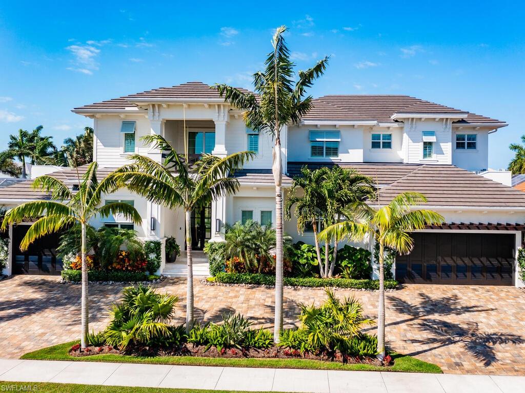 This beautiful, modern beach custom built home was completed in 2019. The two-story great room and expansive floor plan home allows for the perfect amount of natural light with Southwest exposure. The interior features hardwood floors, custom cabinetry and tops throughout, built in wall units, custom closets, 2nd floor wet bar, a large wine cooler, Wolf appliances, and walk-in pantry. This must see property also features a three car garage, a whole home generator, and the most well maintained beautifully landscape yard. You can enjoy the resort style pool all afternoon or quick boating access to the Gulf of Mexico and oversized dock. The lanai is complete with a built-in grill, fireplace, large outdoor living space and expansive roll down screens and Bluetooth Sonos speakers. This home is must see to appreciate the true meaning of Florida style living!
