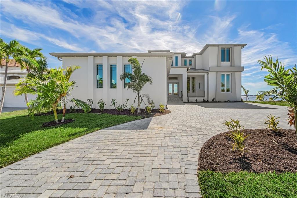 *** HUGE PRICE REDUCTION – Sellers changed their plans and decided to let this UNIQUE RESIDENCE go... *** – YOU CAN'T BEAT THIS VIEW!!! – Gorgeous NEW CONSTRUCTION one of a kind Riverfront Home. The moment you enter this Residence you realize the BREATHTAKING VIEW of the River. – This modern, luxury 2-story CUSTOM HOME is located in Cape Corals sought-after Yacht Club Area. Experience this Waterfront Property with its endless Riverfront Views and natural light throughout. – Almost 4,000 sqft with TWO identical PRIMARY BEDROOMS, 2 Guest Bedrooms plus DEN. Huge Eat-in kitchen. Open floor plan with light filled family-living area. – Both primary Baths are spa-inspired with fully enclosed Glass Shower and with full Wall Tile in all Wet Areas, multiple shower heads, freestanding Soaking Tub and Dual Vanities. Guest bedrooms with En-Suite Bathrooms. Kitchen with BOSCH appliances, CAMBRIA Countertops and Waterfall Island. Many more Features: Zoned Air-Condition. Tankless Water Heater. OVERSIZED three-car garage. Wine cellar wall. Outdoor Summer-Kitchen. Low E Impact Windows and Doors. 12-feet high Ceilings on 1st Floor for airy and inviting Atmosphere. – 
Centrally located to Downtown Cape Coral with its Restaurants, Entertainment and Shops. – Prime Boating Location – short Boat-ride to Sanibel, Fort Myers Beach and several Waterfront Restaurants. Enjoy the FLORIDA LIFESTYLE. Enjoy stunning SUNRISES and SUNSETS from the Spacious Lanai overlooking the River. Or enjoy the SPECTACULAR PANORAMIC RIVER VIEWS from the second-floor Balcony. – So, this WATERFRONT LUXURY could be your new Full-Time Residence, your Seasonal Retreat or even a great Investment Opportunity as Vacation Rental. – Don’ t miss the chance to own YOUR PIECE OF PARADISE!!! – 
*** Due to delays in pool construction, buyers currently have the option to DESIGN their own RESORT-STYLE POOL AREA with Extras such as SPA, Fire Bowl, Infinity Edge e.g. A SUBSTANTIAL DISCOUNT of $250,000 is being offered! ***