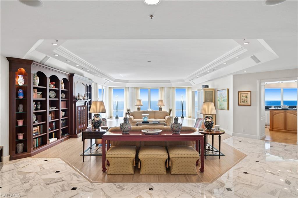 Perched on the 23th floor of the Enclave this remarkable penthouse spans an entire floor, offering breathtaking 360-degree views of the Gulf, city, and Bay, capturing Naples’ most stunning vistas. A split floorplan with four spacious bedrooms, a versatile den, and four and a half baths, this residence provides space and privacy for all. With countless floor to ceiling windows and each room thoughtfully designed to showcase sweeping coastal and city views, there is an unparalleled sense of space and natural light.  The kitchen and family room areas are the ideal space to entertain family and friends while watching the sunset across the pristine coastline and dinner parties are a must with the spacious dining area, fit for families of all sizes.  Additional features such as a full mechanical room, in unit trash chute, spacious laundry room and a private 3 car garage,  this penthouse truly lives like a beach home. Residents will also enjoy direct beach access and The Enclave’s exceptional amenities, with planned renovations to the lobby, social room, pool, and fitness room set to enhance the building’s sophistication. This rare opportunity is perfect for those seeking an elevated lifestyle in Naples’ finest beachfront setting.