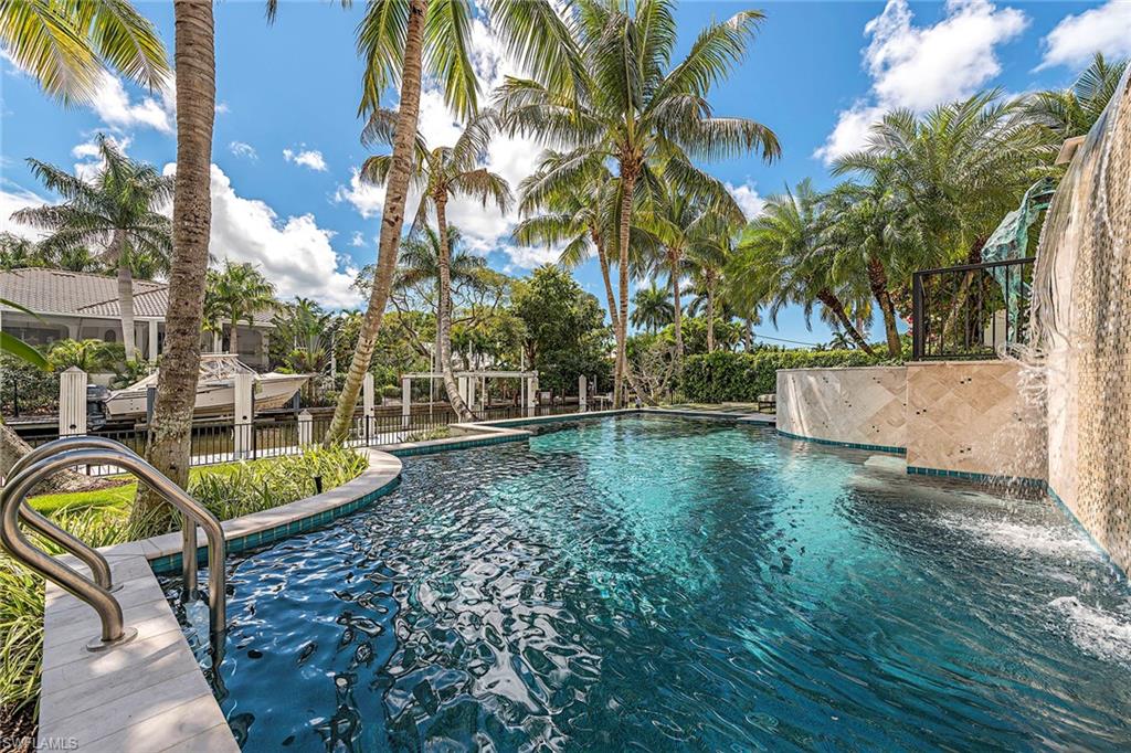 Ideally located in prestigious Aqualane Shores yet steps to the beach and 3rd St S. Dock your boat at the private boat dock with 16,000 lb. lift capacity. Boasting the coveted Southern exposure for all day sun on the pool and boat dock. Special highlights of the home include four en-suite bedrooms, gracious gourmet kitchen with Wolf gas range, Sub-Zero refrigerator, gas instant hot water throughout, large and inviting living room ideal for entertaining, with an enchanting gas fireplace in the living room, Acacia hardwood floors, cathedral ceilings, and all overlooking pool and water views. The master suite is enriched with two walk-in closets and a luxurious spa bath. Enjoy your formal dining room to entertain a multitude of guests. Home was built in 2012 with Hurricane Impact Windows and Doors and hurricane shutters were added on the patio. Sprawling entertaining spaces flow outside to the generously sized patio area that can be enjoyed year-round. Easy and direct access to the Gulf of Mexico. Located in an ideal location close to Gordon Drive, and just minutes to the beach.