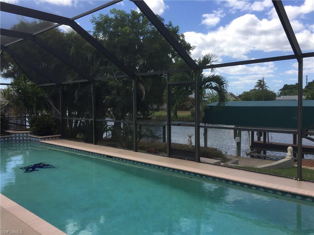 Not many left at this Price!!! Come check out this great Gulf Access home with its over sized pool, Boat Lift with Canopy cover, located just a short ride to the Gulf of Mexico.  Enjoy the sunsets on your covered lanai or sit in the pool with your beverage of choice at the built in Table...just say "this is paradise".  The home offers a split floor plan with two guest bedrooms, great room and master suite.  The front of the home has a unique screened covered patio area that looks into it's own tropical horticulture...you can enjoy the many birds that nest in this area and again, relax and enjoy your piece of paradise.  Come take and look and make this your home today!!!!