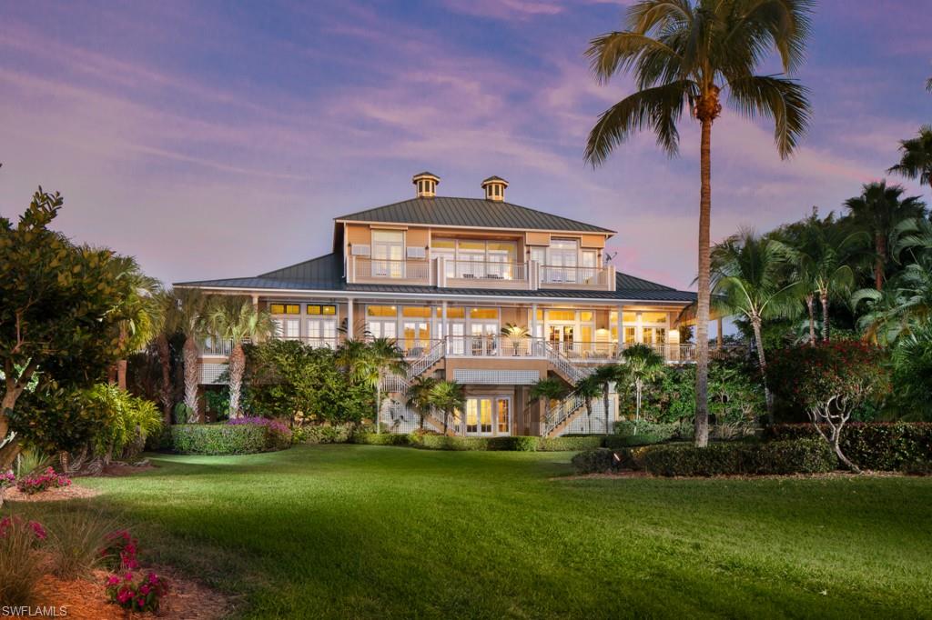This stunning beach house is being offered at an exceptional price. You will be wowed by the ocean views, easy beach access and the charming wraparound veranda that is accessed by French doors from every room. Perfect for hosting family and friends, this three-level home with elevator boasts nearly 6,500 square feet of main living space with a total of over 17,000 square feet and is situated on a direct, Gulf-facing double lot. Enjoy six bedrooms, six-and-a-half baths, gourmet eat-in kitchen with adjoining outdoor grill area, open great room and dining room with soaring ceilings, library and separate study, three laundry rooms, ground-level family room with kitchen,  four-car garage, workshop, backup generator and more. Includes 25-foot boat dock with lift. The ultimate beach and boating lifestyle property.