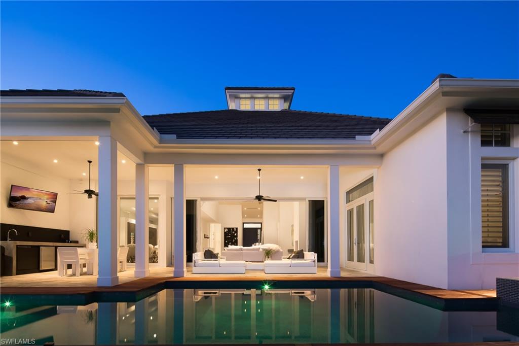 This one of a kind European modernist design home is simply stunning!  Built for easy living and entertaining, this home features 4 bedrooms plus a den, 4 1/2 baths, and a beautiful open floor plan design.  The master bedroom features huge custom walk-in closets and beautiful pool and water views.  The stunning kitchen features top of the line appliances including double wall ovens, built-in espresso machine and cooktop with a retractable vent hood.  Entertaining outdoors is a breeze with the outdoor kitchen, lanai, pool and spa, and a 12,000 pound boat lift and two jet ski ramps.  Fifth Avenue, restaurants and shopping are only minutes away!  Come enjoy everything the Naples lifestyle has to offer!