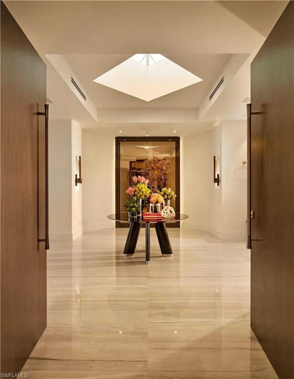 This is a level of luxury to behold. Enter into one of the most exclusive penthouses that Naples has ever seen. Beyond the interior design, this space is centered on 360-degree views. The entire penthouse is outfitted with a range of state-of-the-art LED recessed lighting, beautiful custom furnishings, modern decorative fixtures and versatile LED Kreon art lights to highlight both architectural details and fine art. The flooring is large-format Italian porcelain of 31-by-72-inch slabs that run throughout the interior and exterior of the unit. Crestron and Lutron hybrid automation system for audio, lighting and temperature controls, custom millwork in exotic real wood veneers and high-end Italian melamine are all of note. Custom kitchen has Gaggenau and Sub-Zero appliances, white quartz countertops and a private elevator clad with high-polish mirrored nickel finish. Oversized dual closets, including a cedar closet, sauna, as well as a fitness room with a view. High-end innovative plumbing fixtures, such as the powder room faucet from ceiling and sculptural bathtub in master bath. This penthouse comes completely furnished. Get ready to be in awe!