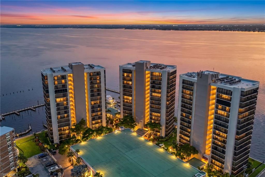 Best Downtown Value & View! Welcome to Unit 403 at Pointe Royale, a beautifully remodeled corner residence offering breathtaking sunsets over the Caloosahatchee River and one of the most engaging waterfront views in Downtown Fort Myers. Positioned at palm-tree level, the expansive wraparound screened lanais provide a unique perspective that blends sparkling river views, lush tropical landscaping, and marina activity.
This spacious 3-bedroom, 2-bath condominium encompasses 2,025 square feet and features more than $140,000 in thoughtfully designed upgrades. Large-format porcelain tile flows throughout the residence, while the stunning chef's kitchen showcases quartz countertops, custom handmade Barker cabinetry with Italian laminate fronts, soft-close drawers and pullouts, a Liebherr refrigerator/freezer, Bosch dishwasher, induction cooktop, and microwave convection oven.  Every detail was carefully selected to combine beauty, function, and everyday convenience.
The primary suite continues the luxury experience with a beautifully updated bath featuring custom cabinetry and quartz finishes. Additional recent improvements provide peace of mind, including a new air handler (2024), new roof (2023), plumbing re-pipe and water heater (2021), updated electrical systems, fresh interior paint, remodeled bathrooms, and a custom acoustic feature wall in the family room.
Located in the Pointe Royale community within the Historic River District, residents enjoy resort-style amenities including a heated waterfront pool, fitness center, tennis and pickleball courts, updated clubhouse, new riverfront pier, covered parking, private storage, secured entry, and 24-hour manned security. Milestone and SIRS reports have been completed, adding further confidence for buyers.
Just steps from Downtown Fort Myers' vibrant dining scene, boutique shopping, art galleries, entertainment venues, and waterfront events, this highly walkable location offers the perfect blend of historic charm and modern convenience. Condo fees include flood and building insurance, cable, internet, water, sewer, trash removal, pest control, landscaping, reserves, professional management, security, and more.
Whether you're seeking a full-time residence, seasonal retreat, or investment opportunity, Unit 403 delivers luxury, value, spectacular riverfront views, and an unmatched Downtown Fort Myers lifestyle. This is waterfront living at its finest.
