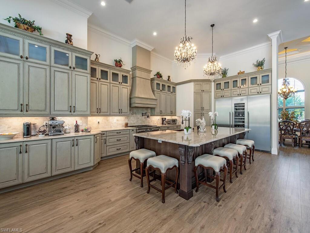 This exceptionally well maintained property is perfect for entertaining with 9,710 SQ under roof, the open floor plan encompasses multiple living areas that flow seamlessly from the indoor space to the outdoor area. The estate hosts 4 en-suite bedrooms, bathrooms, an office, study room and more. The open concept kitchen has French Country custom cabinetry. Thermador appliances. There are two more seating options, a formal dining and kitchen nook with great views. The light filled master suite has several windows, French doors that will take you outside, room for seating area overlooking the pool. The resort style outdoor living space gives you the wow factor! With 3,046 SF of outside entertainment lanai with fireplace, pizza oven, rotisserie smoker and bar area, kitchen equipped with a grill. Designed with family style entertaining in mind! The uniquely designed pool with jacuzzi is perfect to take a quick dip or lounge in the shallow end. The lawn is fully sodded, irrigated, and fenced, the possibilities are endless. There are two separate 2 car tiled climate control garages, security cameras and security system. LISTING IS ONLY FOR 5 ACRES.