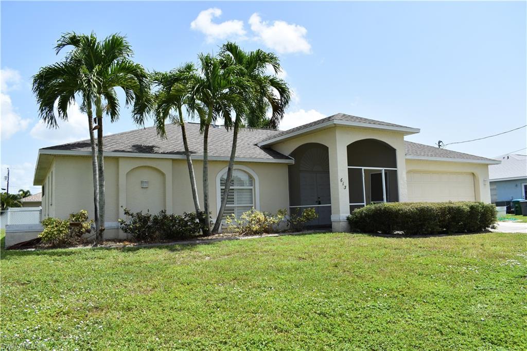 Contemporary charmer across from water in desirable SE location off Academy blvd with bike paths and sidewalk lined streets with 1 year old roof and 5 year old a/c. Convenient to Fort Myers or shops on Del Prado. Raised modern entry with double doors and large screened and tiled entry. Faux wood cherry floors through out except for 2 guest bedrooms. Vaulted ceilings with plant ledges in family room. granite counter tops in kitchen and pass thru to lanai, stainless appliances and disposal. Huge tiled lanai (great for entertaining or perfect to add a pool to later 12X31), 3 sets of pocketing sliding glass doors, plantation shutters, floratam lawn and sprinkler. All city utilities in and paid. This home feels and shows much larger then the sq footage. Don't delay see this Florida dream home today.