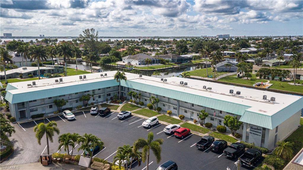 I Wanted To Share An Incredible Opportunity For A New Home. This Property Offers An Unparalleled Waterfront Lifestyle. This Lovely 1st - Floor Condo Is Part Of A Private, 22 - Unit Complex Nestled At The Intersection Of The  Bimini And Vincennes Canal, Offering Stunning Views. You'll Have Easy Access To The Swimming Pool As Well As The Boat Dock Walkways. The Unit Itself Features A Comfortable Split Bedroom Floor Plan With Two Bedrooms And Two Bathrooms. The Owner's Retreat Includes A Walk-In Closet And An En Suite Bathroom. The Guest Bedroom And Guest Bathroom Could Easily Become A 2nd Mini Primary With The Simple Installation Of A Contemporary Barn Door! Throughout The Condo, You'll Find Freshly Painted Interiors, And Updated Flooring. Enjoy Outdoor Living On The Inviting Outdoor Living Area Just Steps From Your Rear Enclosed Lanai Door. Including A Beautiful Heated Swimming Pool, Outdoor Living Areas Including The Fenced Pool Deck, The Dockside Chickee Hut Overlooking And The Intersecting Canals. The Open - Concept Kitchen Is A Highlight, Featuring A Lovely Window Overlooking The Front Parking Areas And Vincennes Street, Solid Surface Countertops, Raised Panel White Cabinetry And A 3 Piece Appliance Package. A Convenient Laundry Area Is Located Just Off Of The Enclosed Lanai. This Intimate Complex Provides An Easy - Going, Carefree Lifestyle. The Building Is Well Maintained AND Has No Special Assessments. The Proximity To The Re - imagined DOWNTOWN Cape Coral Lifestyle Is Within Walking. Additionally, Enjoy (2) Indoor Community Entertainment Rooms. Access To These Shared Common Spaces Is Easy With A Staircase Very Access Very Near To Each End Of The Community. This Truly Is An Unique Opportunity To Make This Lovely Condo Your New Home.