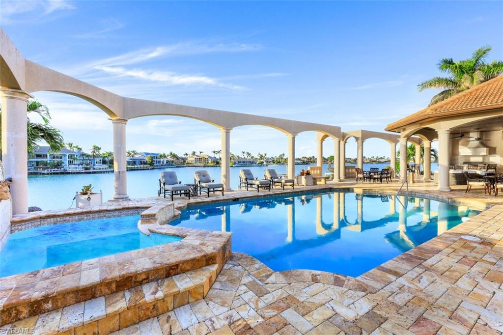 This is an absolute show-stopping, Direct-Water home on a half acre in the prestigious Estates.
One of the greatest assets of this sprawling estates home is that there are NO stairs to climb.   Enjoy an oversized family room with open kitchen and dining areas so that everyone is included in gatherings.  The kitchen boasts Viking appliances with two Viking refrigerators, one Viking free-standing freezer, a Gas Viking stove with double oven, separate built-in Thermador wall oven, built-in microwave, built-in Miele Espresso/Cappuccino machine, and a warmer drawer.  This is truly a ‘chef’s kitchen’ and a joy to cook in.  Did I mention TWO dishwashers, multiple sinks AND a wet bar with two wine refrigerators?
Wait until you see the pool area!  Hosting large parties or events is a breeze with an outdoor kitchen including a built-in gas grill and two drink refrigerators behind a curved bar and PLENTY of furniture for all of the guests!  SUNSETS are AMAZING in this Western-facing backyard all year around!  
Just minutes from all of the restaurants, shopping, and beaches.  It doesn’t get any better than this.  If SUN on the pool is a must, look no further.  See this one soon.