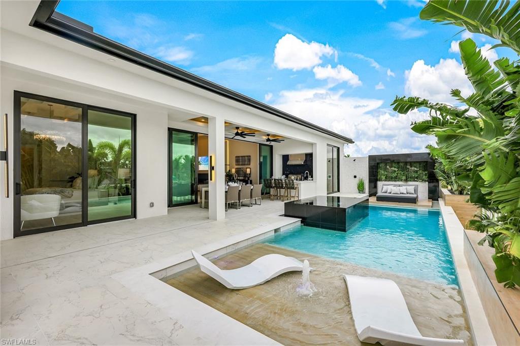 Stunning, contemporary custom built, waterfront home by Lux Development Group. This 4 beds, office, 6 baths,  home comes fully furnished and designed to perfection. Porcelain Paver driveway and 3 car garage with plenty of space for parking and storage. As you step inside, you'll immediately notice the open concept design, creating a spacious and inviting atmosphere. The main living area flooring is done in a 24 x 48 large format Italian porcelain. The custom kitchen features 48 inch fridge, 48 inch gas burning range, Cambria quartz Countertops with full height backsplash and skinny shaker cabinetry. Hidden pantry with floating oak shelving. All the bedrooms have wide plank, French white oak flooring. All bathrooms feature custom tile work, LED mirrors and wallpaper accents. Every room of the home is adorned with custom ceiling treatments.  The centerpiece of the outdoor space is the resort-style pool, completed with a sun shelf and a floating daybed. Outdoor kitchen and cabana. Adjacent to the pool, your own private dock and lift. Overall this Direct Gulf Access home offers the perfect blend of luxury, relaxation and outdoor living.