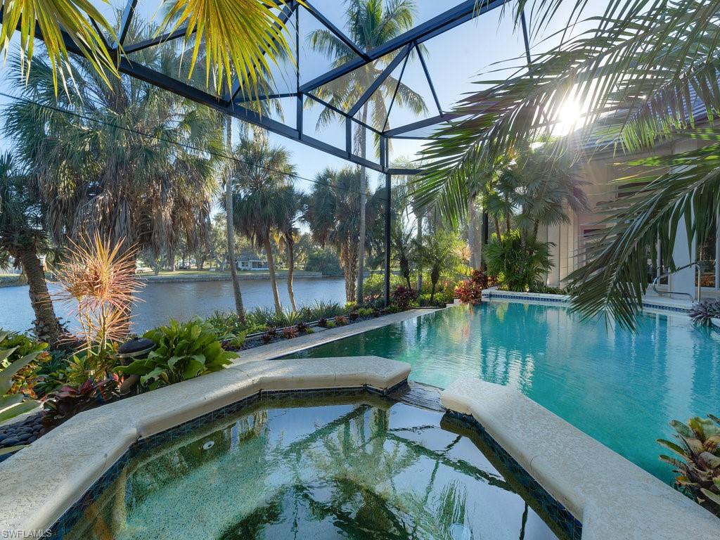 One of 11 homes in exclusive Marina Pointe along the Imperial River with Gulf access.
Magnificent River views of manatees, osprey, dolphins, eagles and more. One of a kind pool area with rare tropical plants offering a true paradise. Nature surrounds this lovely lot with incredible privacy. Resort living at its best to live and entertain.  New roof in 2021.