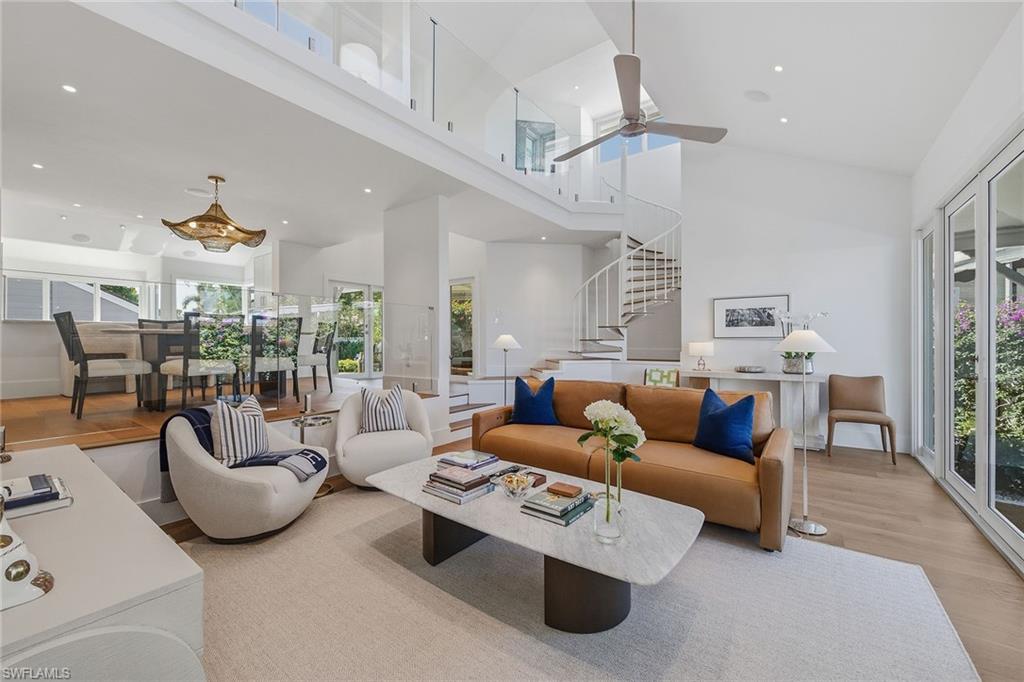 This impeccably furnished, three-bedroom villa with loft and three full baths has been masterfully transformed, pairing architectural refinement with a thoughtful curation of bespoke materials and finishes. Inside, natural light dances across warm oak flooring, softly illuminating a composition of elegant textures and clean-lined sophistication. The reimagined kitchen is framed by walls of glass, opening to lush exterior vistas. Solid wood cabinetry, quartzite surfaces, and a suite of professional-grade appliances elevate culinary moments, while a concealed walk-in pantry with a coffee bar and ice maker ensures every detail is considered. The first-floor primary suite is a tranquil sanctuary, where lake and fountain views offer a natural canvas for serenity. Its spa-inspired bath is finished with soaring ceilings, artisan tilework, and premium fixtures, while the custom-fitted walk-in closet offers a discreet nod to luxury living. A second en-suite guest suite, privately on the first floor, opens directly to the front courtyard, positioned for comfort and retreat. Upstairs, an airy loft leads to an additional guest suite with a full bath, creating a versatile space that adapts effortlessly to rhythms of modern life. But it is the seamless connection between interior and exterior that defines this home’s true spirit. A sparkling, oversized swimming pool anchors the marble-clad courtyard, surrounded by generous lounging and gathering areas designed for sun-drenched afternoons and starlit evenings. Beyond, a screened lanai enveloped in lush foliage invites quiet reflection, while the rear terrace, framed by panoramic lake views, sets the stage for alfresco dining or fireside conversation. This is more than a residence, it is a lifestyle. Pelican Bay offers unmatched resort-style living with exclusive private beach access, two beachfront restaurants, state-of-the-art fitness and wellness facilities, racquet sports, scenic walking and biking paths and more, all set along Naples desired coastline.