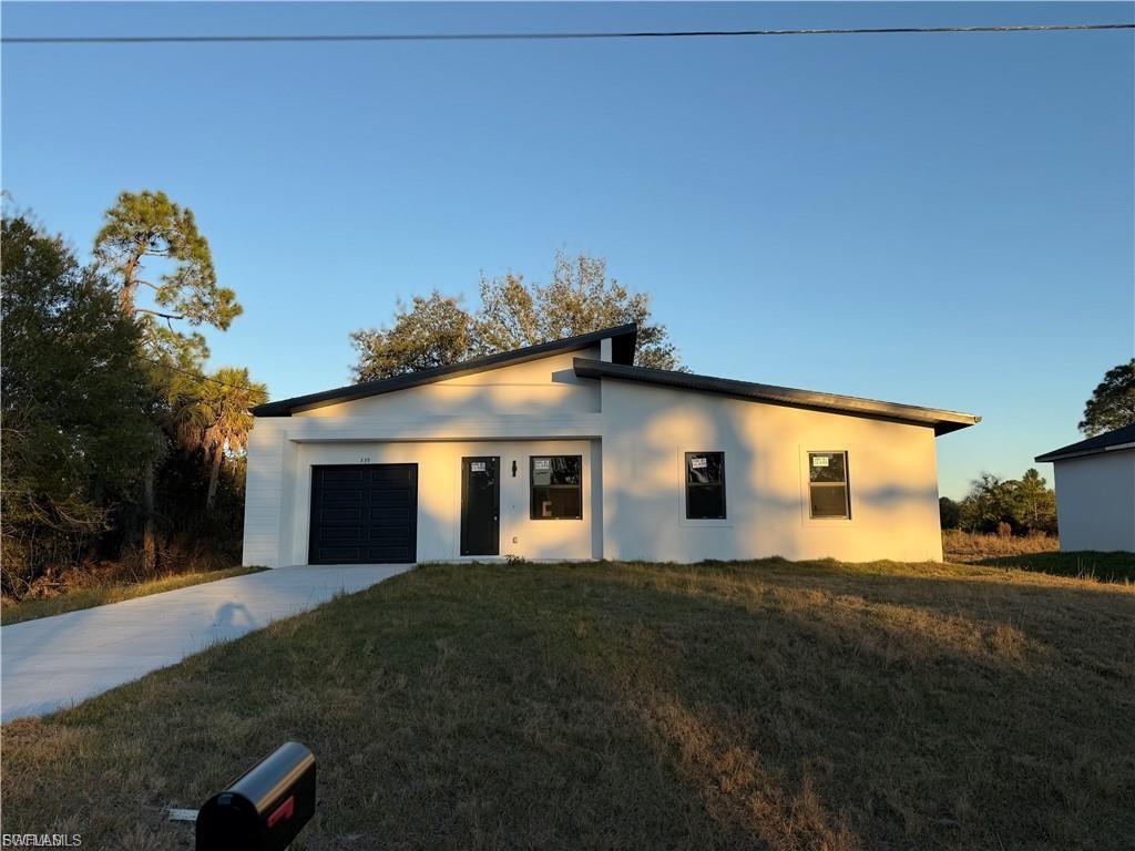NEW CONSTRUCTION!! Fully impact doors and windows, gorgeous home in Lehigh Acres! This stunning 10ft high single-family home 3 bedrooms , 3 Full bathrooms, an open concept layout, 1-car garage, large backyard with room for a pool. Stainless steel appliances, white quartz countertops in the kitchen, washer and dryer hook up, With Tile flooring throughout the house make it stylish and easy to maintain. This home is built with the highest standards and care.