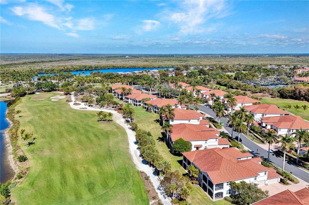 Gracefully positioned on the second floor with sweeping, tranquil views of the JW Marriott Hammock Bay golf course, this refined residence captures the essence of elevated coastal living.  Nearly 2,500 square feet of thoughtfully designed interior space unfolds in a light-filled, open-concept layout featuring three bedrooms plus a den, soaring vaulted ceilings, and elegant flooring throughout. The gourmet kitchen is appointed with custom cabinetry and designed to both inspire and entertain, seamlessly connecting to expansive living and dining areas.
Walls of pocketing sliders open to a generously sized screened balcony, creating a seamless indoor-outdoor living experience and framing breathtaking western sunsets over the manicured fairways. Built in 2003, the home offers a private elevator, attached two-car garage, newer hurricane-impact windows, a newer roof, updated appliances, and a newer HVAC system—delivering comfort, convenience, and peace of mind.
Set within the gated and impeccably maintained Rialto enclave of Hammock Bay, residents enjoy the opportunity to pursue social (social membership without golf for this unit is transferable at the Marriott fee without waitlist), granting access to Hammock Bay and Rookery clubhouses, as well as the world-class amenities of JW Marriott Marco Island, including beachfront experiences, spa services, fitness classes, dining, and curated events. This is an exceptional opportunity to enjoy a lifestyle defined by elegance, privacy, and resort-style sophistication. Convenient to all that Marco Island and Naples has to offer.