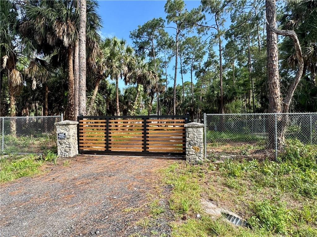One or more photo(s) has been virtually staged, AI generated or rendered.  PRIME LOCATION, PRIVACY, AND ENDLESS OPPORTUNITY! UNMATCHED POTENTIAL IN SW FLORIDA! 
Welcome to this unique 3-bedroom, 3-bathroom home situated on a prime 2.27-acre oversized lot in one of the fastest-growing areas in Southwest Florida. Surrounded by mature trees, this wooded retreat offers ultimate seclusion just minutes from everyday conveniences. THE STANDOUT FEATURE OF THIS PROPERTY IS HAVING ACCESS TO TWO INDEPENDENT ENTRANCES FROM TWO DIFFERENT STREETS, Jung Blvd W and 16th Ave NW, making it incredibly accessible and entirely unique. The expansive acreage provides a rare opportunity with plenty of space to add a pool, build a guest house, or set up a detached workshop. With no shortage of space for RV and boat storage, this property is a true paradise for those looking for freedom and flexibility. Already has a mother in law suite in the covered garage. Opportunities like this do not come along often—schedule your showing today!!! Thank me later