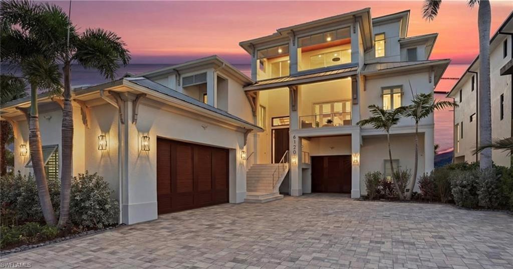 Masterfully Reimagined Luxury Gulf-Front Estate by Alair Homes with Panoramic Beach and Gulf Views—Perfectly positioned on Court Street on the desirable south end of Fort Myers Beach—one of the few Gulf-front locations not directly on Estero Boulevard—this extraordinary coastal haven offers a rare blend of privacy, sophistication, and direct access to the island’s world-renowned white sand shoreline.
Architectural gables, a custom-crafted entry door, and a striking open-stringer staircase with elegant white oak treads and handrails introduce the home’s refined coastal aesthetic. Inside, French white oak flooring extends throughout the luminous interior, complemented by designer Visual Comfort lighting and expansive glass capturing breathtaking Gulf views and endless coastal horizons. A private elevator and integrated smart home technology enhance everyday living with modern convenience and effortless control.
The residence features a wide open floor plan designed for both relaxed coastal living and sophisticated entertaining, anchored by a striking three-sided 10-foot DaVinci Fireplace with a double-pane glass system, creating a dramatic architectural focal point. The chef’s kitchen is designed for both culinary creativity and entertaining at scale, showcasing a Wolf 8-burner gas range, Cove dishwasher, dual Sub-Zero refrigerator and freezer units, two sinks with a convenient pass-through window, and a separate catering kitchen. A dedicated lounge with front lanai access features two Sub-Zero wine and beverage centers, creating an inviting setting for gatherings and sunset evenings.
Outdoor living embraces the rhythm of the Gulf with spaces designed to capture sea breezes and glowing sunsets. A saltwater infinity-edge pool and spa overlook the beach, accompanied by an expansive pool deck, outdoor kitchen, and pool bath—creating a seamless transition between elegant interiors and the beauty of coastal living.
The residence offers four ensuite bedrooms and two half baths, including a spectacular Gulf-front primary suite occupying the entire second level. This private sanctuary features a balcony overlooking the Gulf, a morning bar, and a spa-inspired bath with soaking tub, walk-in shower, and plantation shutters that frame the serene coastal setting. A second laundry room on this level provides added convenience.
Lush tropical landscaping, meticulously maintained grounds, and an oversized garage with capacity for up to seven vehicles further enhance the property’s thoughtful design.
A remarkable Gulf-front estate offering timeless coastal architecture, exceptional craftsmanship, and an unparalleled lifestyle along the shores of Fort Myers Beach. This is the pinnacle of luxury beachfront living!