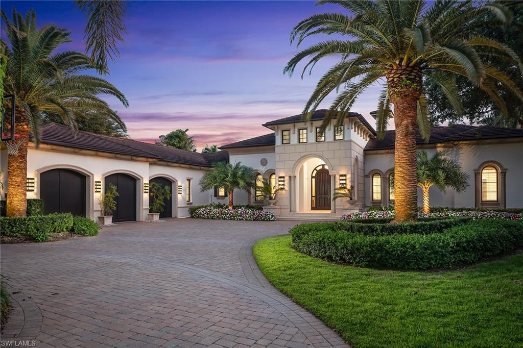 On one of the most desirable lots in Escada at The Ritz-Carlton Tiburón, this is a rare opportunity to own a thoughtfully updated luxury estate with sweeping lake and golf course views. Move-in ready, this light and bright residence offers an expansive floor plan all on one level, featuring soaring ceilings, European white oak flooring, custom millwork and designer lighting that create a refined ambiance throughout. Multiple living areas are designed for relaxation and entertaining, including a stunning open-concept gourmet kitchen with neutral finishes, custom cabinetry, a large island, gas cooking, and top-of-the-line Wolf and Sub-Zero appliances. The expansive primary suite is a private retreat with spa-like finishes, dual closets, dual baths and French doors opening to the covered lanai. Three generously sized guest suites, a large den, and a separate study provide flexible space for comfort and functionality. Outdoors, enjoy a resort-style setting with an impressive gas-heated saltwater pool and spa, water features, summer kitchen, fireplace, covered living areas, upgraded lush landscaping, and a spacious patio overlooking the 14th fairway with preferred southwestern exposure. Additional highlights include impact glass with electric shutters and screens, whole-house generator, newer roof, updated pool equipment, newer HVAC systems 2020–2025 and more. A three-car garage with circular drive and a double-gated entrance complete this exceptional offering. Tiburón membership is optional for access to championship golf, beach privileges and world-class resort amenities. This property represents the pinnacle of Naples living, where timeless luxury meets everyday comfort in a premier gated community.