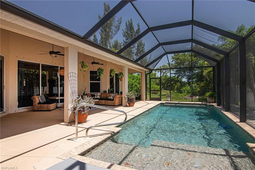 Welcome to this beautifully maintained pool home, ideally located in a NO FLOOD ZONE! Offering the perfect blend of spacious living, thoughtful updates, and exceptional outdoor entertaining, this move-in-ready home is sure to impress. Recent improvements include a new roof (2022), A/C (2019), reverse osmosis system, new washer, new well pump, and an oversized 2.5-car garage!

From the moment you arrive, you'll be greeted by a paver driveway, lush mature landscaping, and outstanding curb appeal. Inside, the expansive open floor plan is complemented by soaring ceilings, elegant tray ceilings, and an abundance of natural light, creating a warm and inviting atmosphere. A formal dining room provides the perfect space for hosting holidays, dinner parties, or family gatherings.

The spacious kitchen is designed with both function and style in mind, featuring custom cabinetry, stainless steel appliances, generous counter space, and an open layout that flows seamlessly into the main living areas—ideal for entertaining or everyday living.

Retreat to the oversized primary suite, complete with a luxurious ensuite bath featuring dual vanities, a relaxing soaking tub, a walk-in shower, and ample space to unwind.

Step outside to your private backyard oasis, where the screened lanai showcases a sparkling pool with a sun shelf, a covered under-truss seating area, and a fully fenced backyard offering both privacy and plenty of room to relax, entertain, or play.

Combining quality updates, a spacious and functional layout, and an incredible outdoor living space, this home offers the best of Southwest Florida living. Don't miss your opportunity to make this exceptional property your own!