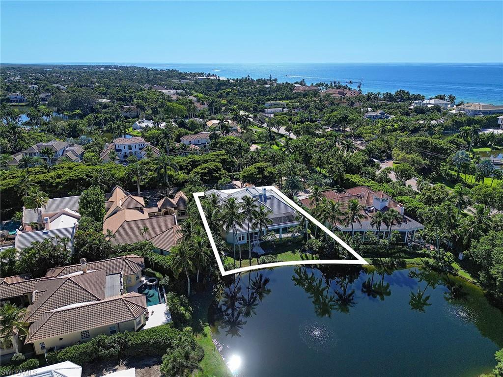 In one of Naples’ most unique and highly coveted enclaves – just 34 homes sitting behind the only guard-gated community in downtown Naples – this custom built 1997 estate on lot 2 offers serene views of the lake behind. With 4 bedrooms, a den, a 3-car AC garage, and high ceilings, the home provides a perfect canvas to create a new vision for this very well kept one owner home. A new roof has just been completed. This is an Associate Membership property affording the new owner the opportunity to join what will be the premier beach club in America, the famed Port Royal Club. Little Harbour is located just across from the 21st Avenue South and Gordon Drive beach access, placing the Gulf’s idyllic shoreline just moments from your door.