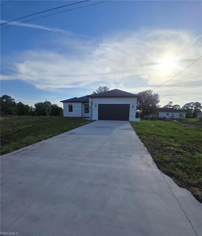 NEW CONSTRUCTION IN LEHIGH ACRES!
Welcome to this stunning brand-new construction home located in the rapidly growing community of Lehigh Acres, Florida. This beautifully designed residence offers an open-concept floor plan with spacious living areas, high ceilings, and abundant natural light throughout.
The modern kitchen features quartz countertops, custom cabinetry, stainless steel appliances, and a large island perfect for entertaining. The spacious primary suite offers a walk-in closet and a luxurious en-suite bathroom with dual sinks and a walk-in shower. Additional bedrooms provide ample space for family, guests, or a home office. Built with quality craftsmanship and contemporary finishes, this home includes impact-resistant windows and doors, porcelain tile flooring throughout, energy-efficient features, and a two-car garage. The covered lanai provides the perfect space to relax and enjoy Florida's beautiful weather, with plenty of room to add a pool.
Conveniently located near schools, shopping, dining, parks, and major roadways, this property offers the perfect combination of comfort, style, and convenience. Whether you're a first-time homebuyer, seasonal resident, or investor, this move-in-ready home is an exceptional opportunity.
Schedule your private showing today and experience the best of new construction living in Lehigh Acres!