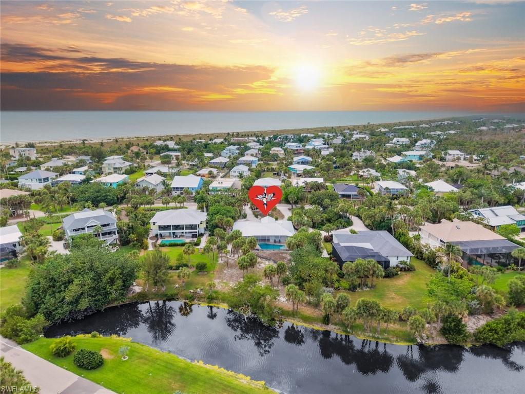 Move in tomorrow! Fully furnished, professionally remodeled, private beach access, heated pool, and one of Sanibel’s most sought after neighborhoods. Everything stays—just bring your suitcase. Located just steps from private deeded beach access in the coveted beachside development of Château Sur Mer, this beautifully remodeled 4-bedroom, 3-bathroom home offers the perfect blend of luxury, privacy, and convenience. Situated on a serene lakefront parcel overlooking preserve with .6 of an acre, this exceptional property features serene views of native wildlife and the tranquil surroundings. The home was meticulously renovated by Kennedy Construction and is truly a contemporary beauty. The spacious, open-concept living areas are designed for both entertaining and enjoying island lifestyle.Whether you're hosting guests or relaxing with family, this home offers an ideal indoor-outdoor flow. The gourmet kitchen is a chef’s delight, featuring a Thermador refrigeration wall, built-in microwave, slide-in cooktop with hood, and dishwasher. The stunning Level 5 Quartzite countertops are complemented by a vitreous glass backsplash and custom cabinetry, making this space both functional and visually striking.The split-bedroom layout provides ample privacy, making it an ideal setup for owners and guests alike. The luxurious primary suite includes a beautifully crafted bath with shiplap walls and custom closet built-ins, ensuring a retreat-like atmosphere. High-end finishes extend throughout the home, including custom window treatments and a programmable Lutron lighting system. Other thoughtful improvements include a resurfaced saltwater pool with new interlocking pavers, a new seamless metal roof installed in 2017, impact glass windows and doors, and a newly fenced portion of the yard. This property is not only an elegant family residence but also offers excellent investment potential, given its proximity to the white sandy beach, charming Captiva Island, local amenities such as the Sanibel School, recreation center, CROW, and the Shell Museum. Golf carts are approved for travel within Château Sur Mer, making daily life even more convenient and enjoyable. With deeded beach access just steps away, this home truly embodies the best of island living.