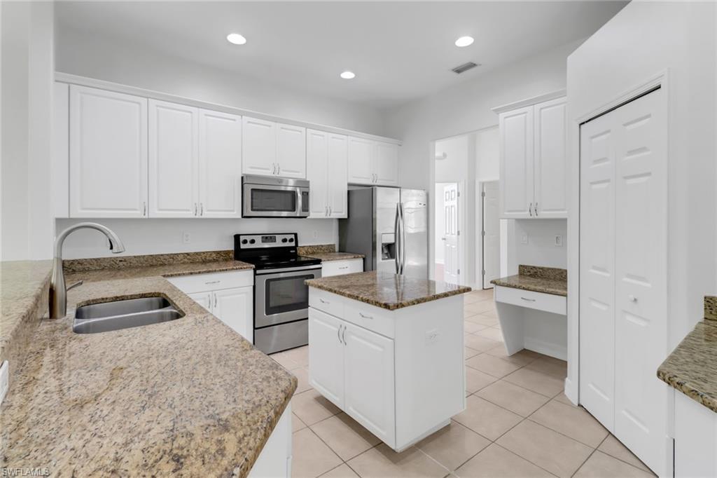 This remarkable single-level 4-bedroom + den home is nestled on a sprawling 2.5-acre lot, offering an exceptional combination of luxury and functionality. The open floor plan is highlighted by high ceilings and tile flooring throughout the living areas, with warm laminate in the bedrooms for a cozy touch.

The updated kitchen is a chef’s delight, featuring granite countertops, a large center island, stainless steel appliances, and built-in cabinetry for ample storage and style. The formal dining room, breakfast nook, and separate family and living rooms provide versatile spaces for entertaining and everyday living.

The spacious master suite is a true sanctuary, boasting two large walk-in closets and a transom window that brings in natural light. Outside, an oversized lanai invites you to enjoy the tranquility of the expansive property, while the garage features a sleek epoxy-coated floor for added utility and appeal.

This home is perfect for those seeking a blend of modern design, thoughtful details, and serene surroundings.
