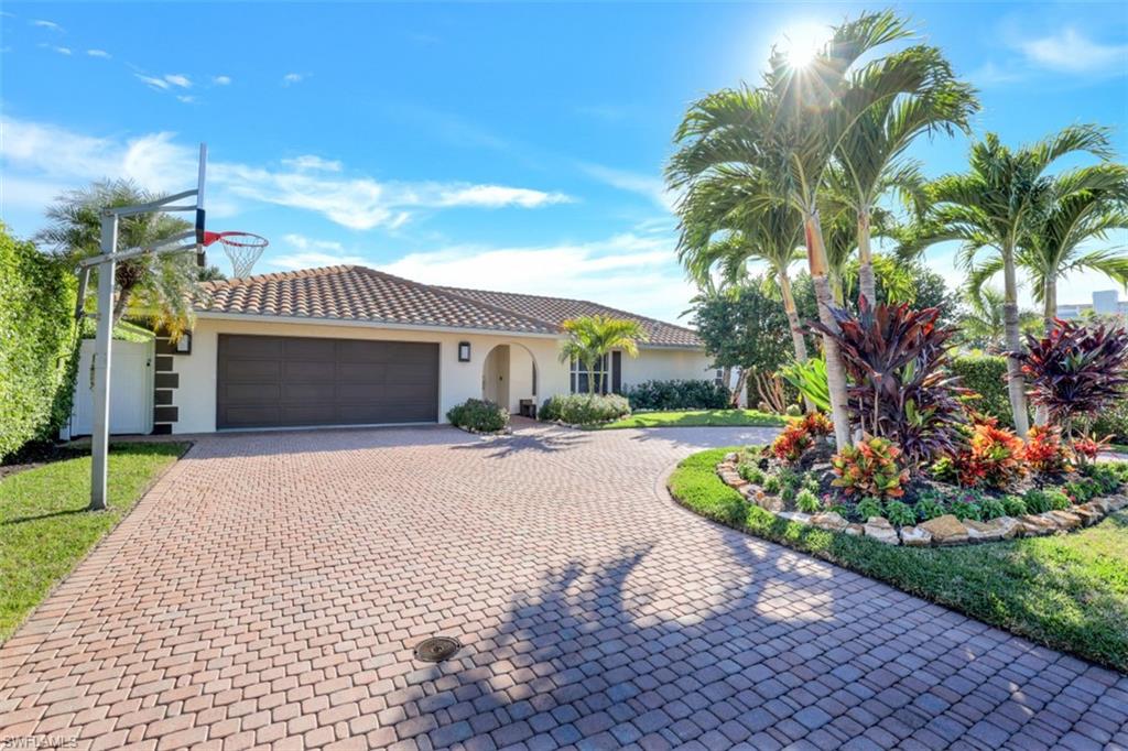 GORGEOUS updated Southern exposure home with grandfathered boat house. Located on one of the most desirable streets in Conners / Vanderbilt Beach this home has all of the finishings buyers are looking for: impact resistant windows and doors, level 5 wall finish, modern kitchen and baths, newer tile wood finish flooring, custom closet systems, large patio for entertaining, smart home technology, boat house with 10k lb lift and 2nd floor deck to enjoy the gorgeous Naples sunsets. Other important updates included: PGT windows and doors, portable generator 2021 (transfer switch with 4 40lb tanks), 2011 roof, pool deck and spa addition by Nassau pools in 2014, plantation shutters throughout, new interior shaker doors and frames, Emteck door hardware on interior and exterior doors, closets systems in all closets, large laundry / mud room, etc. Conveniently located in the Conners on Vanderbilt beach you can walk to the beach, Mercato, shopping, dining and much more - and NO HOA fees!