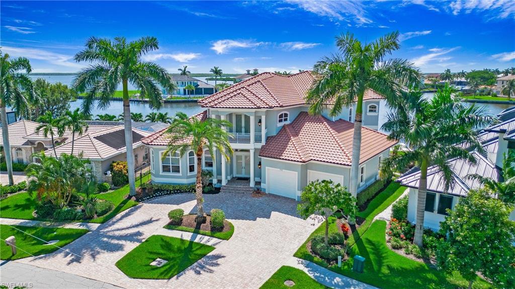 Welcome to 739 Fairlawn Ct, Marco Island, FL – a stunning blend of luxury and sophistication in a breathtaking waterfront setting. As you cross the bridge into Marco Island, the sight of the Marco Island Yacht Club and Marina signals your arrival to a paradise known for its pristine white sandy beaches and serene coastal beauty.
Pulling into the driveway of this meticulously maintained estate, you'll immediately appreciate the grandeur of this custom-built, two-story home. Featuring four spacious bedrooms, each with its own ensuite and large walk-in closet, and a large pool bath, this residence boasts a three-car garage with an approximate 35' bay and access to the boat dock. With 124 feet of prime water frontage, it offers panoramic views of the bay and Marco River and direct access to the Gulf of Mexico.
From the moment you step inside, the thoughtfully designed floor plan and high-end finishes capture your attention. The expansive 10' glass sliders frame the spectacular wide-open water views, ensuring a seamless blend of indoor and outdoor living. The newer roof, well-maintained mechanicals, impact doors and windows, and a robust 24KW generator provide peace of mind and convenience.
The heart of the home is the impressive kitchen, equipped with a gas cooktop, Thermidor appliances, solid wood cabinetry, custom wood shelving, and an ice machine – a dream for any culinary enthusiast. A 12' island centers the gourmet kitchen, offering ample space for meal preparation and casual dining. Crown molding, tile floors, and an open floorplan enhance the sense of space and elegance. The residence also includes a private elevator for added convenience.
The second floor features a loft with a front balcony and a spacious gathering room, along with a large second-floor outdoor lanai offering incredible views, perfect for family activities or entertaining guests.
The outdoor living area is a true oasis. It includes a large pool with a sun deck and spa, a custom large built-in table with a granite top, and an outdoor grill area. The outdoor living area boasts exceptional travertine tile, and a floating dock with the capacity for a larger boat and a motorized platform for smaller boats or jet skis completes this waterfront paradise.
Wake up every morning to stunning water views, whether enjoying the beautiful sunrises from your balcony or the stunning sunsets in the evening. This home promises to impress and captivate. 739 Fairlawn Ct is not just a residence; it's a luxurious waterfront lifestyle. Experience the epitome of coastal living in this exquisite Marco Island estate.