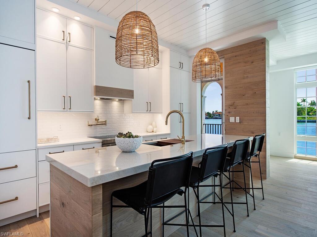 Totally updated, thoughtfully reinvented floorplan in this first floor three-bedroom, 3 ensuite bath condo at iconic Venetian Villas.  Gutted from top to bottom, with impact windows, Legno Bastone white oak floors, Wolf/SubZero appliances, new kitchen and bath cabinetry, countertops and fixtures, new doors, hardware, air conditioning, hot water heater, plumbing, electric and laundry.  Expanded waterfront windows in the great room from almost floor to ceiling.  Shiplap galore.  Has to be seen to be appreciated.  Never before has a Venetian Villa been created in this oh-so-current style.  Boat slips available to owners; private beach access; walkable to Venetian Villas.  The very best of Naples.