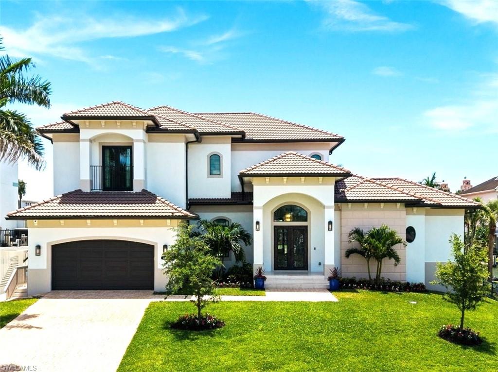 Welcome to a newly constructed 2023 Gulf-access waterfront custom residence in The Conners at Vanderbilt Beach, one of Naples’ most sought-after boating communities. Perfectly positioned on a quiet south-facing cul-de-sac lot with sweeping canal and bay views, this exceptional home offers effortless luxury boating and beach living just moments from Vanderbilt Beach.
Built for both sophistication and peace of mind, this elevated all-block construction home sits 12 feet above base flood elevation and features all impact-rated windows and doors, a new 99-foot seawall, new dock with jet ski lifts, whole-home Generac generator, home automation, Kinetico whole home water filtration system, sunset lanai, outdoor shower and a resort-style saltwater pool and spa.
Designed to maximize waterfront living, walls of floor-to-ceiling corner-pocket sliders create a seamless indoor-outdoor lifestyle filled with natural light and stunning water views. The expansive grand room features a striking fireplace and elegant gathering spaces, while the chef’s kitchen showcases custom cabinetry, quartz countertops,  gas cooktop, and an oversized island ideal for entertaining.
The thoughtfully designed floor plan includes 4 spacious bedrooms, 5.5 baths. including a pool bath, a private office or flex room on the first floor with adjacent full bath, and an additional second floor family room. Every space is finished with refined coastal elegance and designed for comfortable luxury living.
Outdoor living is equally impressive with expansive waterfront terraces, an outdoor kitchen and dining area, multiple lounge spaces, fully fenced yard, and a sunset deck capturing forever bay views.  Enjoy direct boating access through Vanderbilt Bay and Wiggins Pass to the Gulf, watch dolphins swim by, fish from your dock, or head out for waterfront dining, a sunset cruise or a day on the boat or jet skis.
Whether hosting guests or enjoying peaceful mornings by the water, this home delivers the quintessential Naples waterfront lifestyle. Located just minutes from Mercato, Pelican Bay Community Park with new pickleball courts, The Ritz-Carlton Beach Resort, La Playa Beach Resort, Waterside shops, Mercato and nearby private beach clubs that you can join including the newly approved Paraiso Beach Club, this extraordinary residence blends luxury, convenience, and the very best of coastal living.
