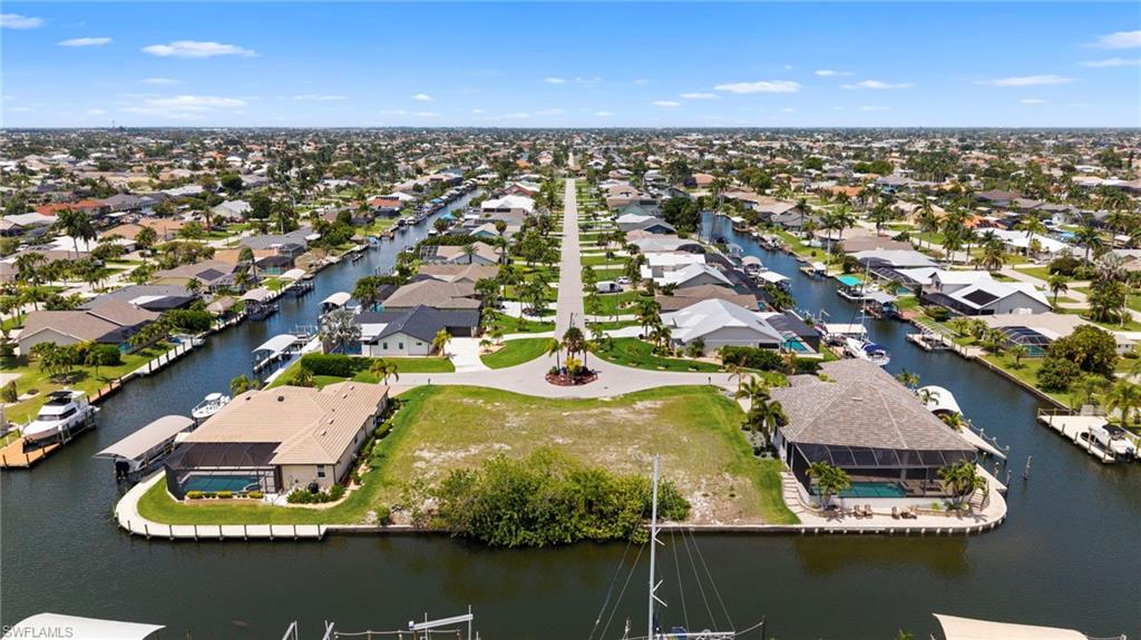 Exceptional opportunity to own one of the largest waterfront homesites currently available. This oversized triple lot offers approximately 150 feet of waterfront on the Underhill Canal with direct Gulf access—no bridges and no locks—making it ideal for boaters. Enjoy a short, hassle-free ride to the river and open water. The highly desirable southern rear exposure provides sun on your future pool all day long. Located at the end of a quiet cul-de-sac, this property offers both privacy and convenience, with easy access to shopping, dining, and everything Cape Coral and Fort Myers have to offer. Whether you're looking to build a spacious custom home, invest in a premium waterfront property, or secure the perfect location for your future dream home, this lot checks all the boxes. Rare size, prime location, and unbeatable boating access—opportunities like this are hard to find.