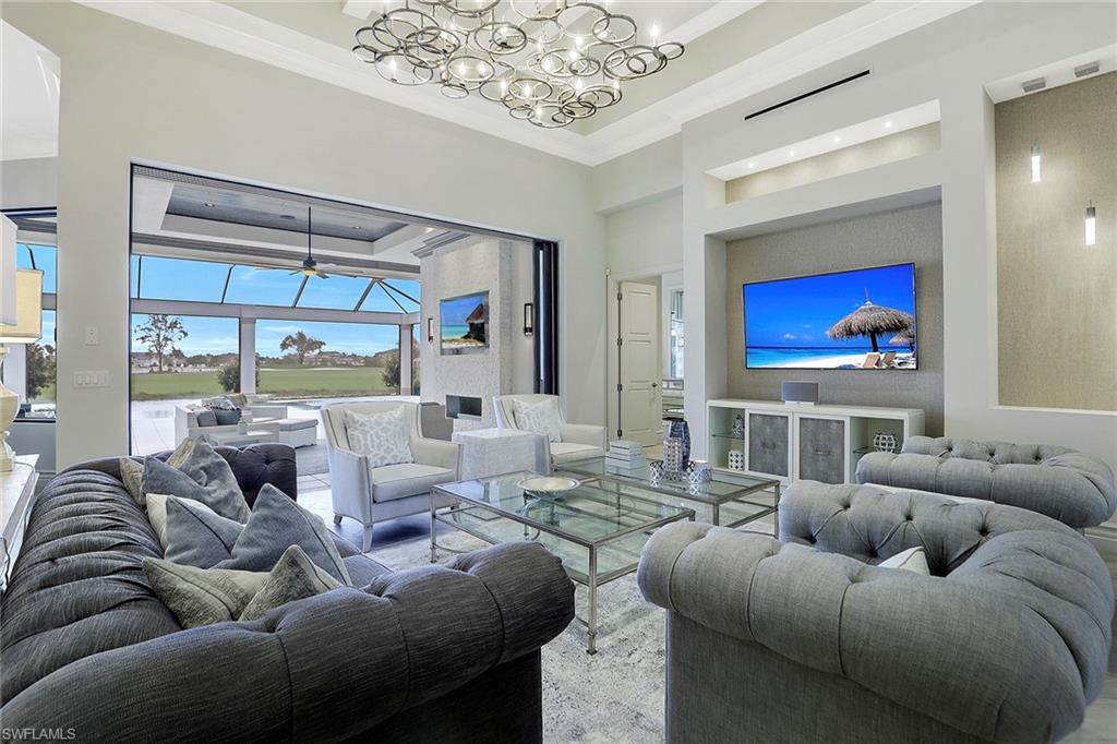 Rare opportunity is PRICED TO SELL IMMEDIATELY. One of the best water & golf course views in sought-after Talis Park. Large circular drive for ample parking & ease. Light-filled Great Room with 16 ft ceilings. Custom features and top quality craftsmanship. Tone-on-tone coastal elegance & soft clean lines. Modern wood-look porcelain tile & (2nd floor) wood floors. Designer features, gourmet kitchen, 2 center islands, state-of-the-art appliances, full-wall backsplash, breakfast nook. Nearly 2,600 square feet of elegant outdoor living, infinity edge pool/spa, outdoor kitchen, bar island, floor-to-ceiling fireplace with built-in TV. Master bedroom retreat with 14 ft ceilings, spectacular master bath, dual walk-in shower, soaking tub. Custom built-ins and closet systems throughout.