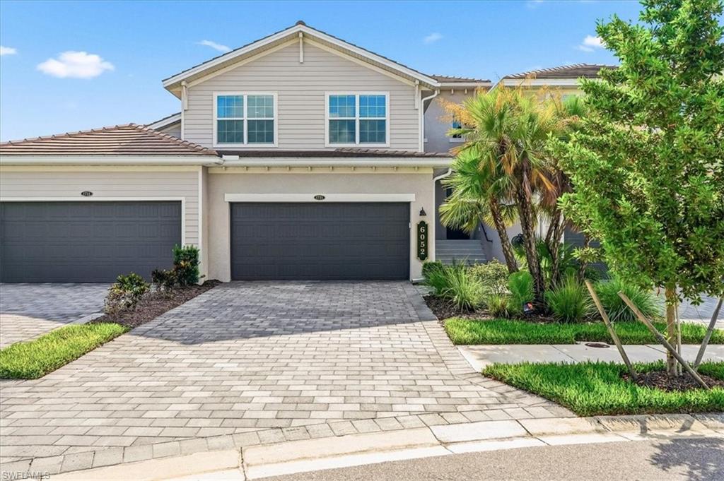 Exceptional opportunity at The National Golf & Country Club in Ave Maria. This Bay Creek model coach home offers 3 bedrooms, 2 bathrooms, and a 2+ car garage, featuring a spacious open floor plan designed for both everyday living and entertaining. Comes complete with bundled golf and social memberships. Sold turnkey, this home includes top-of-the-line furnishings and finishes, making it move-in ready or ideal for seasonal use. The interior includes thoughtful upgrades such as feature walls with custom trim work, ceiling fans, outdoor patio furnitures, stainless steel appliances,  and impact windows and doors throughout. The screened-in balcony provides peaceful water views, creating a comfortable outdoor space to relax and unwind. Residents of The National enjoy access to a gated community centered around an 18-hole Gordon Lewis designed golf course, along with a resort-style clubhouse, pool, fitness center, spa, salon, tennis, pickleball, outdoor bar and restaurant, and formal dining options. Located in Ave Maria, additional amenities include parks, walking and biking paths, sports fields, dog parks, shopping, dining, and more. Ideal as a primary residence, seasonal retreat, or investment opportunity.