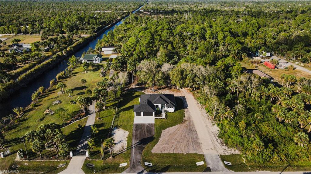 MOTIVATED SELLER BRAND NEW 2025 CONSTRUCTION IN GOLDEN GATE ESTATES 4 BEDS. 3 BATH. 3- CAR GARAGE. 2.27 ACRES NO HOA IMPACT WINDOWS & DOORS MODERN OPEN LAYOUT WITH HIGH CEILINGS OUTDOOR KICTHEN & PATIO CANAL AT THE REAR HORSES OK CASH BUYERS WELCOME
