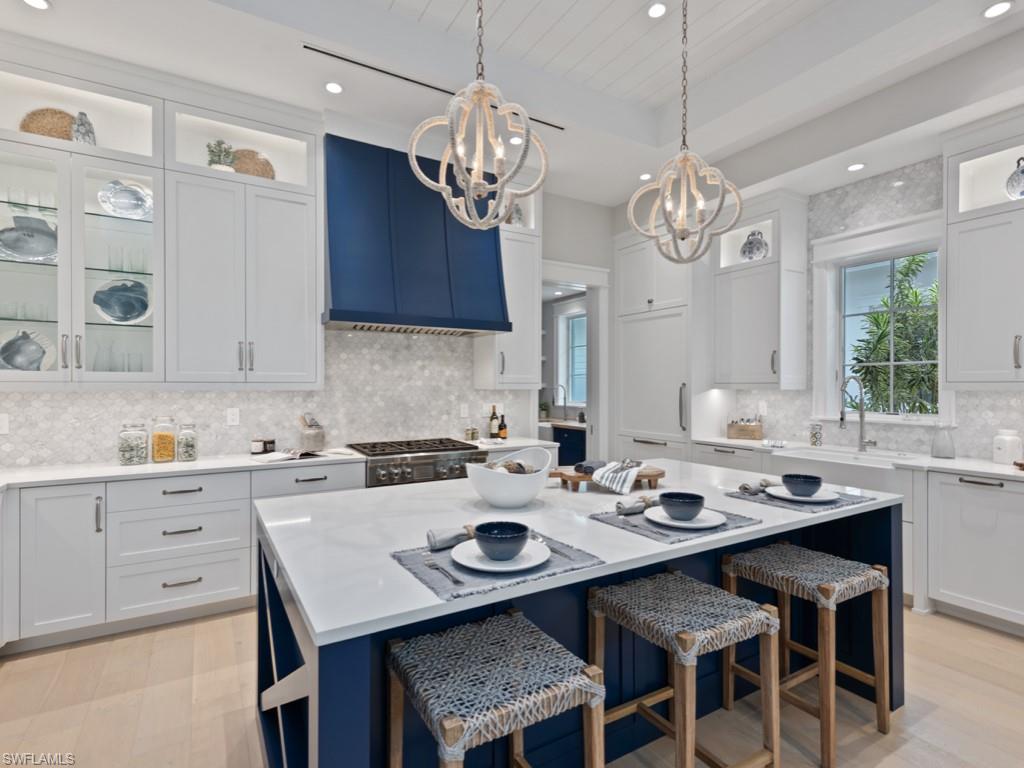 Luxuriously appointed and FURNISHED by Clive Daniel Interiors, this Captiva II plan (Lot 29) in Mangrove Bay offers 4 bedrooms including private-entry guest cottage above the garage. PRIVATE BOAT SLIP INCLUDED. Masterfully designed single-story main house with custom Ruffino cabinetry, white oak wood flooring throughout, specialty mosaic tile work in baths, tongue & groove ceiling & wall treatments, gourmet kitchen with Wolf/Subzero appliances (including gas range) & expansive covered outdoor terrace w/ grilling station, outdoor fireplace & electronic screen protection. Tropical pool & spa area with wet wall feature and Shellstone decking. CBS construction,standing seam aluminum roof,natural gas feed & built to accommodate a home generator system. Mangrove Bay is nestled along the Gordon River in Old Naples & adjacent to Baker Park, the Naples Dog Park, 5th Avenue Shopping & Dining & the Gulf Beaches. Mangrove Bay offers a luxury resident Wellness Center with state-of the art- fitness room, resident lounge, ground level kayak/paddle board storage and private boat ramp.