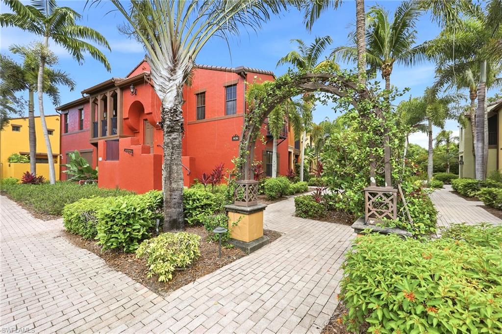 One or more photo(s) has been virtually staged, AI generated or rendered.  No stairs! Enter this adorable home through a lush, tropical courtyard setting. The San Clemente ground-level flat is one of only two floor plans in all of Ole that easily accommodate wheelchair access. This desirable floor plan boasts two primary suites each with its private lanai. The expansive great room with a spacious dining area is ideal for entertaining or simply relaxing at home. Over $18,000 of builder upgrades include granite countertops, stainless steel kitchen appliances, 42-inch upper kitchen cabinets, crown molding, tile on the diagonal and wood shelving, just to name a few. The spacious two-car garage adds valuable storage space, while impact-resistant windows enhance security and comfort. One of the greatest benefits is being just a short distance from the Village Center, where you can enjoy a drink at the pub, watch a film in the old-time theater, relax by the resort-style pool or exercise in the fitness center. The community also features tennis, basketball, bocce and volleyball courts, as well as scenic bike and recreational trails ideal for enjoying the Florida sunshine. With Naples renowned beaches, Marco Island, and the shopping and dining options of Fifth Avenue South only minutes away, you can easily experience everything Southwest Florida has to offer. This property isn't simply a home, it's a way of life. Offered unfurnished, tenant furniture has been digitally removed from photos. A monthly annual lease is in place until 6/7/2027.