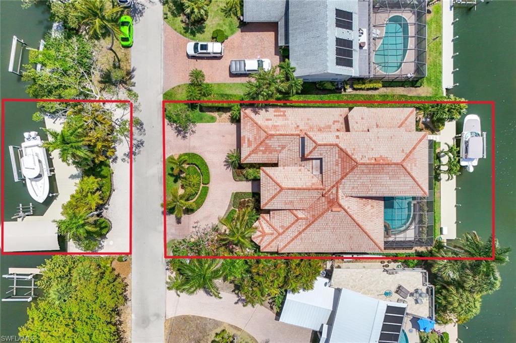 This home is located on Jewel Box Avenue, a highly sought after quiet cul-de-sac street in Oyster Bay.  Jewel Box Avenue has canals, water access, on the front as well as the back of the house.  Includes a 12,000 Lb boat lift on the back dock and two (2) boat lifts (7,000 Lb and 27,000 Lb) plus a jet ski lift on the front dock across the street.  Currently two (2) of the lifts are leased, adding to any rental income potential.  Enjoy endless sunsets and fourth of July fireworks with southern views of Naples Bay from the second floor with corner pocket sliders leading out to the balcony.  The two (2) corner pocket sliders on the first floor lead out to the infinity pool, waterfall spa and covered patio grill area with a gas grill and electric smoker.  This home boasts four (4) bedrooms, four (4) full baths, monitored alarm system, tile throughout, bamboo floors in the den, hardwood floors on stairway and second floor, quartz countertops, stainless steel appliances, tin ceiling over dining area, coffered ceilings in living / family room and three (3) newer HVAC systems plus a split unit.  Home is a stone's throw to the open waters of Naples Bay and minutes to world class beaches, shopping and dining.  Due to elevation there were no issues with recent storms.