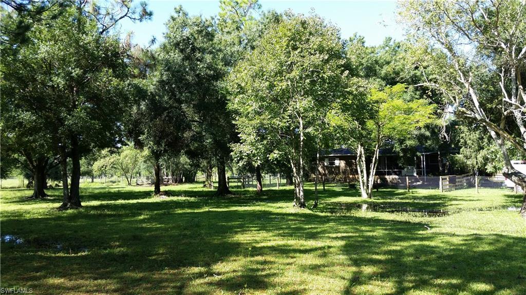 Breathtaking 2 acre property with a 3bd/2ba home! (so bring your animals, RV & toys) YOU'LL DEFINITELY WANT TO CALL THIS HOME!  Freshly painted inside & out. Large master bedroom with walk-in closet, kitchen features granite counter-tops and wood cabinets. Floors are new tile and new wood laminate throughout, crown molding & window treatments. Whether you sit on the front screen porch or out back under the pergola you will feel at peace on this beautiful property. Large oak tree for some shade. There is a detached garage/workshop and horse barn with 2 stalls, electric and auto waterers. Property is fenced & cross fenced with electric. NEW Well & water system too. Acreage with the convenience.....easy access to I75 and stores within 10 min.