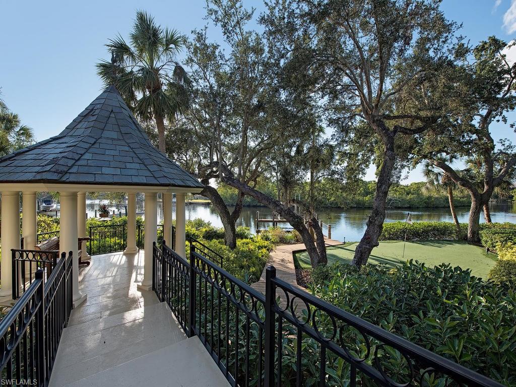 H.12608 - This is the most spectacular home site in Bonita Bay.  You are instantly captivated by this one of a kind riverfront setting with direct Gulf access!  Nestled amongst tropical vegetation & live oaks, this home offers privacy and nature at its finest.  This hidden gem checks all the boxes for entertaining family and friends both inside & out. Features include a boat dock with electric lift, gazebo, putting green, elevator, remodeled kitchen, media room, game room with kitchen and bar, wine room, 3 car garage w/AC, slate roof, outdoor kitchen, state of the art security system, storm shutters, 3M window protection and much more!  Bonita Bay, a gated community, welcomes owners to a complete luxury lifestyle.  Bonita Bay has 5 golf courses, an 18 court tennis center, 4 restaurants, a new “Life Style” 18,000 s/f fitness center, private beach, full service marina, 3 parks, 12 miles of biking/walk trails, and much more.