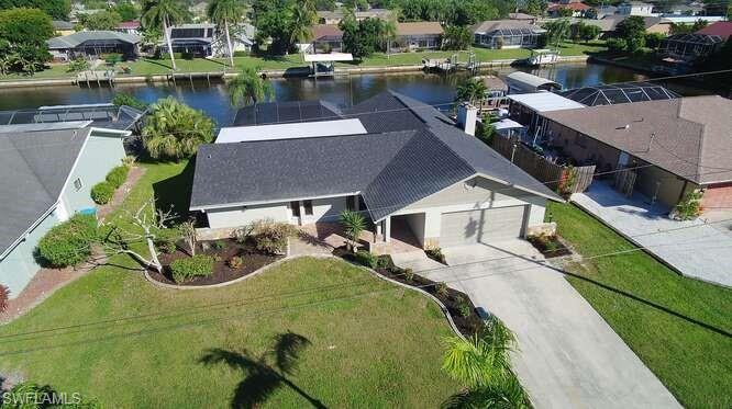 Professionally Remodeled Gulf Access Pool Home Home Nestled In Beautiful Cape Coral Florida! This 3 Bedroom, 2 Bath, 2 Car Garage Home Has A Beautiful Open Floor Plan With Updates That Include A New 30-Year Dimensional Shingle Roof, New Interior And Exterior Paint Including The Garage, Garage Floor, New Waterproof Luxury Vinyl Flooring Throughout, New All Wood Cabinets In The Kitchen And Bathrooms, New Granite Countertops Throughout And Backsplash In The Kitchen, New Stainless Steel Energy Star Appliance Suite, Newly Renovated Swimming Pool With New Screen Cage And Travertine Patio, New Ceiling Fans, New Baseboard And Trim, New Interior And Exterior Doors, New Light Fixtures, New Outlets And Switches, New Smoke Detectors And New Interior And Exterior Hardware And Finishings. This Home Has An Expansive Rear Screened Pool Patio Overlooking A Beautiful Canal. This Quiet Neighborhood Offers A Convenient Location To Veteran's Pkwy, The Beaches, Shopping, Restaurants And Golf Courses. This Home Shows Like A Model! Come By And See It Today!