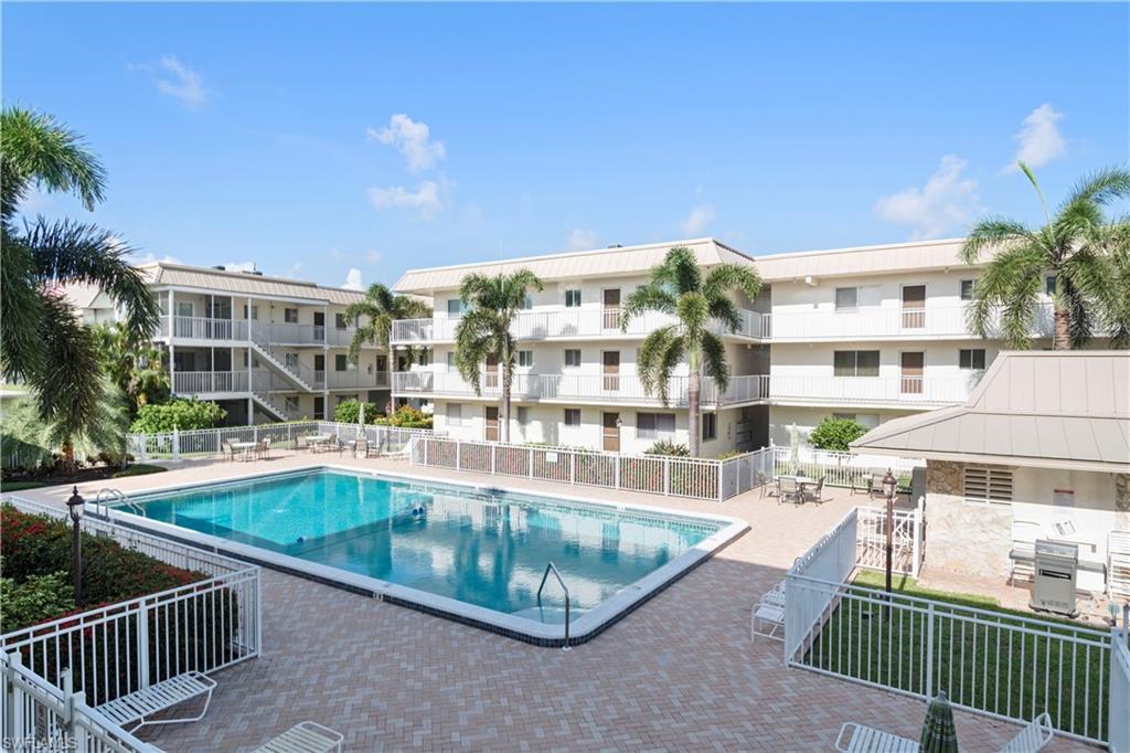 Updated Olde Naples condo situated on the beach side of Tamiami Trail North. Recent upgrades include NEW A/C SYSTEM (2018), WATER HEATER (2019), REFRIGERATOR (2019), granite, crown molding, kitchen and bathroom cabinets, designer paint, furnishings and accessories. Second floor end unit overlooking magnificent heated pool. Common elevator access and one reserved parking space.  TASTEFULLY TURNKEY FURNISHED AND MOVE-IN READY. Conveniently located within walking distance of world class shopping and dining on Fifth Avenue South and just blocks from Naples' finest beaches, main library, medical facilities, and Starbucks. The Central Garden community boasts sauna facilities, poolside shower, extra storage, barbeque grills, and lush mature landscaping.