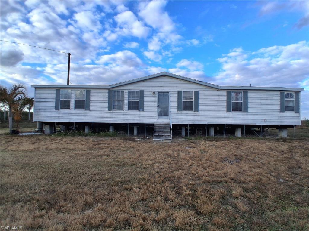 One-of-a-kind property available for sale. This property is a total of 29.66 acres including 25.33 acres of pasture, 2.83 of native pasture and comes with a 2002 DW 1,920sq ft 60ft by 32 ft, 3-bedroom 2-bathroom Manufactured Home on 1.50 acres with electric. Property is on well and septic. Secluded but only 35 min away from the city of Clewiston. No city taxes. Able to have to animals or grow crops/trees. Currently has fruit trees such as bananas, limes and guavas. There is a Pole barn 25ft by 25ft, 625 sq ft and a pond on property. Parcel is fenced around the perimeter and has additional fenced-in areas within parcel for your animals. There is a canal that runs along the middle of the parcel the length of the property for drainage as well as a rear canal separating from the northern adjacent parcel. Not in a flood zone or wetland area.  This property is unique and can be yours today. Call for your private showing!