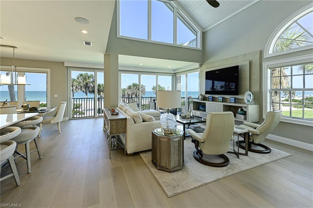 This furnished Barefoot Beach Gulf front Villa home was completely reimagined and renovated to the highest standards including: enlarged windows that provide amazing beach views and sunsets to the west, north, and south, an open floor plan that lives like a single family home, 3 en-suite bedrooms plus a half bath, a large sun deck with ultimate views, beautiful white kitchen with accent large island, quartzite countertops, Wolf range & Thermador refrigerator/freezer, a large two story great room, a dining area overlooking the beach, and panoramic aqua water & white sand views everywhere. The renovation included new impact windows and doors, plumbing, electrical, insulation, drywall, AC, cabinetry, flooring, baths, kitchen, fixtures, railings, garage doors, millwork, interior doors and was completed in 2020 (original construction 1990). There is also a 2 car garage and a screened lanai with electric shutters on the beach. This is one of only 4 Villa end units that provides light throughout and the Villa with the best Gulf of Mexico views because this building sits further west than the other building. The Villas at Barefoot Beach is located in Collier County inside the gates of Barefoot Beach and offers 24 hour patrolled security, two swimming pools, a spa, a new beach boardwalk with sunset seating and is an HOA (not condominium) - you own the ground under the Villa. Do not miss this rare opportunity to own a direct beachfront like new Villa for a fraction of the cost of a beachfront home.