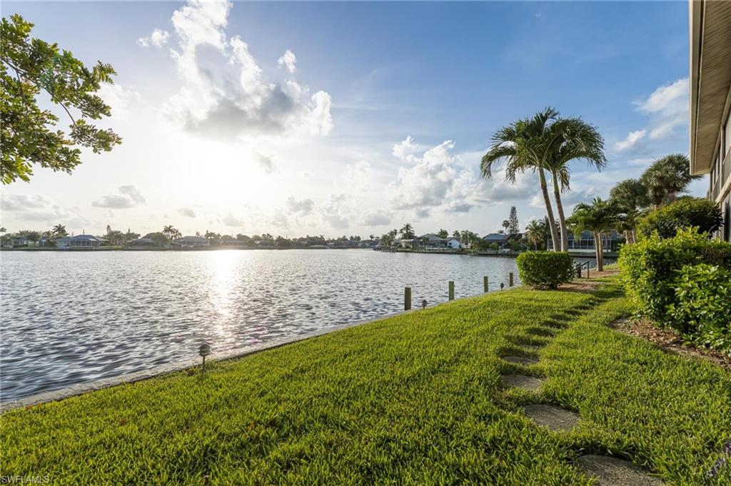 STOP SCROLLING & SCHEDULE YOUR PRIVATE TOUR! Unbelievable views from this western facing lanai overlooking the lovely Lake Louise. Bring your BOAT, community dock offers ample space & gulf access via Redfish Cove. Whether fishing for tarpon off the boardwalk or just enjoying the wild life, Lake Louise will not disappoint. You will love watching sunsets, dolphins, & manatee from your oversized 30' x 7' screened patio. Both the great room & owner's suite offer breathtaking views & sliders to the lanai. Offered furnished, this 2 bedroom, 2 bathroom, 2nd story condo was recently refloored w/ luxury vinyl plank flooring.  BRAND NEW A/C w/ 10 year warranty for new owners. Much of the interior was recently painted as well. This condo boasts lots of extra storage inside & an outdoor carport shed. New front door is coming. Washer-Dryer in the unit. Assigned covered parking + additional parking for guests near pool area.  Recently renovated community pool area features a heated pool. Conveniently located in SW Cape Coral, near Santa Barbara/Cape Coral Pkwy intersection & walking distance to Publix.  HOA Fees of $1,350 a quarter include both cable & water.  ACT NOW BEFORE THIS UNIT IS SOLD!!