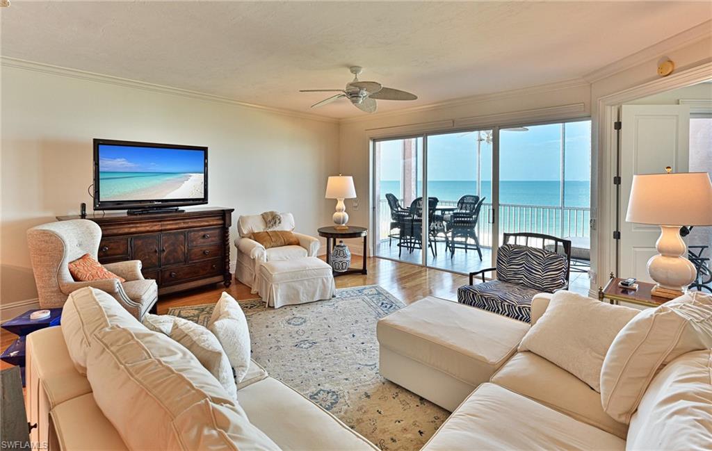 This direct Barefoot Beach Club Gulf front 2 bedroom 2 bath condominium is located within the gated community of Barefoot Beach in North Collier County.  This condo was reimagined in an upscale “Island Beach” design with an open floor plan where the kitchen is open to the dining room area and great room which are all open to the large screened lanai overlooking the white sand beach and turquoise waters of the Gulf. Features include white wood kitchen cabinets, upgraded stainless steel appliances, granite counters, oak wood flooring, millwork throughout including crown moulding, chair rail, door & window casing and column treatment, electric lanai shutters, totally updated master and guest baths and a master bedroom with wide long Gulf views and direct access the the lanai. Best of all the turnkey designer furnishings are available to purchase with the condo for an easy, no stress move in. Building 253 features 2 elevators and a 150+acre preserve across the street. Barefoot Beach Club is a well managed & maintained family friendly Condominium Association. Gulf access boat dock leasing options are available. The Clubhouse, located right on the beach, offers a new swimming pool with oversized deck area plus a large fitness center overlooking the Gulf of America. There will be a second resort style pool constructed soon (assessment for pool has been paid by Seller). Barefoot Beach is Collier County’s premier gated Beach to Bay community featuring Royal Palm lined brick paver streets, 2 security guards 24 hours, and no public parking within the community. Option to join the Club at Barefoot Beach (located in the community) which offers casual & fine dining restaurants, pool & beachside food, drinks, chair service, indoor & outdoor bars, ice cream & coffee shop, tennis courts with pro & a full events calendar. (Subject to current waitlist). Barefoot Beach is centrally located to dining, entertainment, golfing, arenas & is close RSW Airport, the Promenade & Coconut Point.