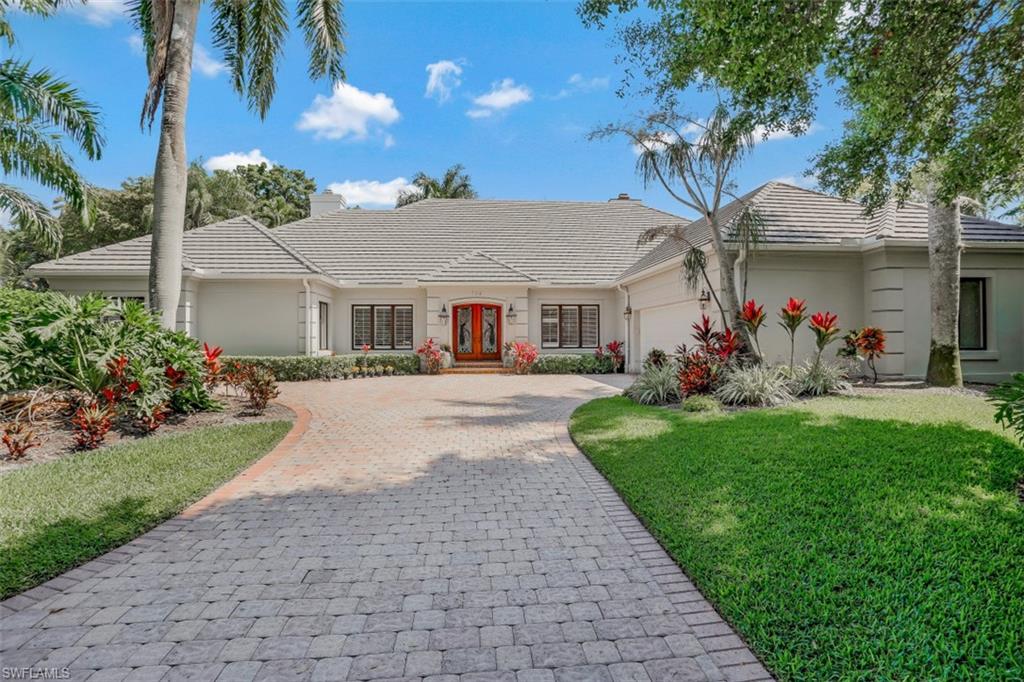 Tropical Oasis and extremely Private Yard.  Situated on a cul-de-sac just steps from Artis-Naples and Waterside Shops in Pelican Bay Woods.  Dramatic entrance blanketed in Brazillian hardwood welcomes all who enter.  Immediately you are taken through the spacious living room to the garden terrace ringed in royal palms. Relax in the picturesque gazebo w/hot tub, take a dip in the southern facing pool AND pick bananas, mangos, oranges and more from the lush garden. Enclosed game room w/pool table and grill overlooks pool and garden. The massive master bedroom includes two ample walk-in closets, fireplace and glass enclosed area perfect for a home office or quiet reading space overlooking the tropical garden. Three bedrooms, three baths, den/office, formal dining room, living room, family room, kitchen, breakfast area and multiple impact glass enclosed verandas are available for your enjoyment. Two-car garage with work bench is air conditioned and has access to the house and terrace. Dogs and children will delight in playing in this spacious backyard.  Lovingly maintained and ready for a new family to enjoy.  Spectacular curb appeal! SEE 3D TOUR ATTACHED AFTER PHOTOS IN MLS LINK!