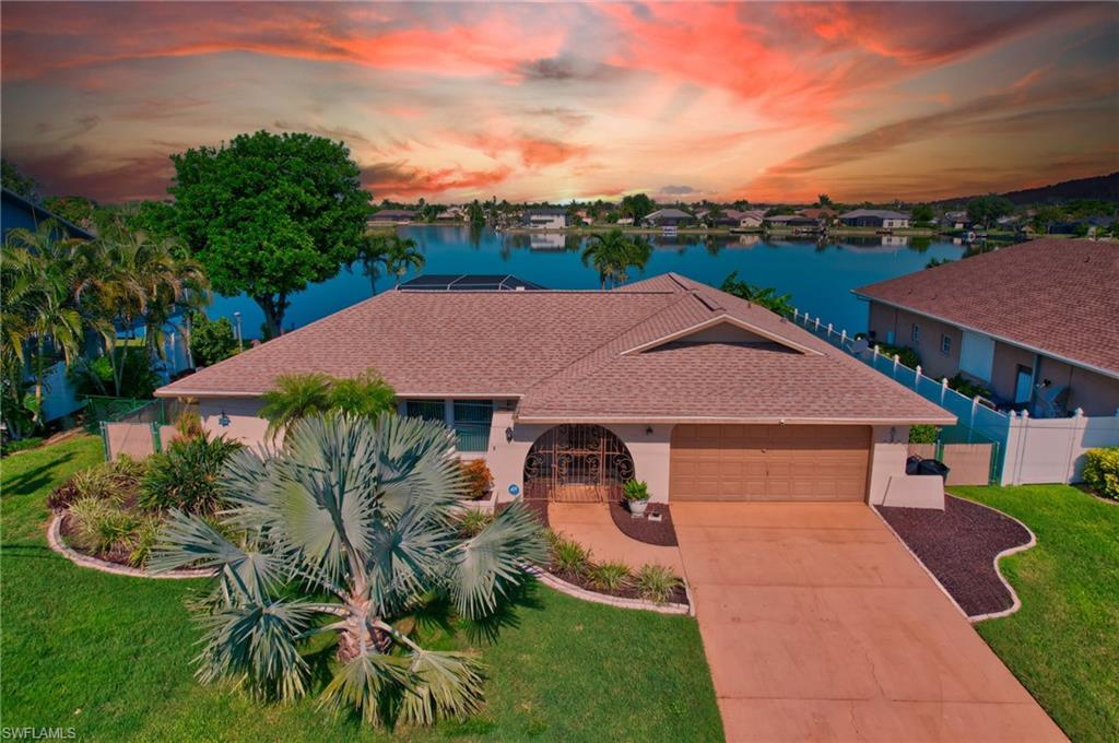 Turnkey lakefront pool home with western exposure, wide freshwater views, private dock, heated pool, and proven short-term rental income potential in desirable Southeast Cape Coral. Welcome to your own slice of paradise! Perfectly positioned on a freshwater lake with expansive water views, this beautifully updated 3-bedroom, 2-bathroom home captures breathtaking sunsets from its coveted western-facing backyard oasis. Thoughtfully renovated and tastefully furnished with light, airy, modern finishes, this turnkey residence offers the ideal blend of comfort, style, and Florida living.
The spacious layout features multiple living areas, providing plenty of room to relax, entertain, and gather with family and friends. Step outside to enjoy the heated pool, unwind on the private dock overlooking the lake, or take in the spectacular sunsets reflecting across the water. Major updates provide added peace of mind, including a resurfaced pool in October 2022, new furnace and air conditioner in January 2025, and full repiping completed in May 2026.
Fully furnished and stocked, this home is truly move-in ready and has a proven track record as a successful short-term rental, making it an exceptional investment opportunity as well as the perfect personal retreat. Located in one of Cape Coral’s most desirable neighborhoods, you’ll enjoy convenient access to shopping, dining, entertainment, and all that Southwest Florida has to offer while still enjoying the tranquility and beauty of waterfront living. Punta Gorda Airport and Southwest Florida International Airport are each about 30 minutes away, making travel from other parts of the country easy. Whether you’re searching for a primary residence, seasonal escape, or income-producing property, this exceptional lakefront home delivers the very best of the Florida lifestyle.