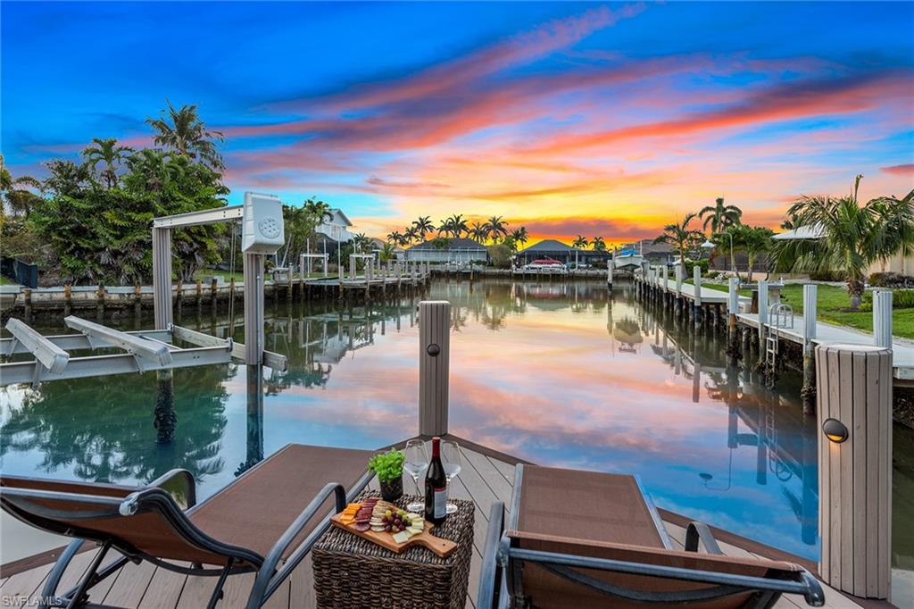 Boating enthusiasts will love direct Gulf access & private dock with 20K-lb and 10K-lb lifts accommodating 39-foot and 20-foot boats. Experience the ultimate indoor-outdoor lifestyle you’ve been dreaming of in this spectacular Marco Island residence. A dramatic staircase in the sunlit foyer introduces you to a fully furnished 3,861-square-foot, 4-bedroom, 3.5-bath layout. Notice thoughtful details from the vaulted ceilings over the main gathering areas and tray bedroom ceilings to the designer lighting, detailed baseboards and impact windows/doors throughout. The open gourmet kitchen inspires the home chef with KitchenAid stainless appliances including gas cooktop and wine cooler, custom cabinetry, and walk-in butler’s pantry. The 2 master bedrooms on the first floor provide lanai access and spa-like en suites with dual sinks, large walk-in showers and separate soaking tub. Entertaining is bliss on the screened-in lanai with a long water view showcasing a wood plank ceiling and built-in grill by the heated pool and spa. Other features include an oversized 28’x17’ media room with soundproofing, 3-car garage, new AC and pool heater. 2009 renovation with second-story addition!