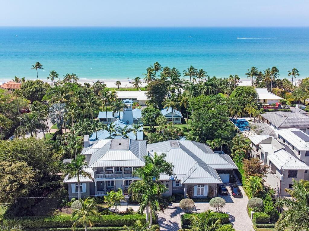Nestled on the SW corner of 8th Ave S is a 1st time offering. This take, on a “West-Indies” inspired home w/ clean lines throughout, creating a private oasis w/a sophisticated, warm coastal look. A premier, sought-after location just steps to the beach, Historic 3rd St S & 5th Ave S. Stofft Cooney Architects penned this 2015 Kurtz constructed “Palm Breeze” masterpiece. Illuminated by natural light w/a 2-story entry welcomes you into a stunning great room w/all you’d expect to entertain family-friends. European white oak wood flooring throughout, Thermador gourmet kitchen, causal/formal dining, wet bar & flanked w/ Nano glass wall system luring you to the outdoor living. Enjoy alfresco dining in the electric screened lanai by the cozy fireplace. Secluded lush backyard w/private gate off the beach entry. Take a dip in the pool/spa & sundeck. A double door entry, luxurious bath, custom closet, exercise room, & terrace complete the master suite. Three guest ensuite stand ready to comfortably greet your guests. A 3-car garage, 2 elevators, generator, & screened lanai are additional features. Don't miss this spectacular home 6500 SF of Olde Naples perfection…Capture the Naples Lifestyle.